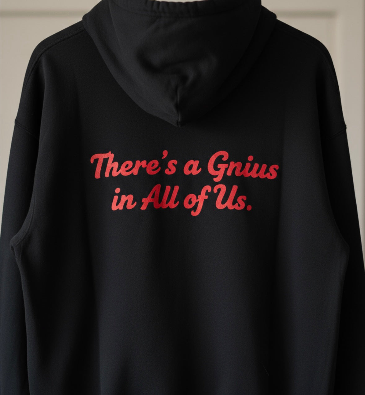 Black Triumph hoodie by shopgnius featuring a front pocket and drawstring hood, displayed on a hanger.